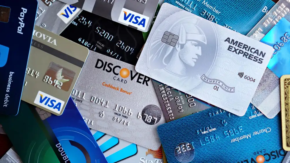 Close-up image of various credit cards including Visa, Mastercard, and American Express.