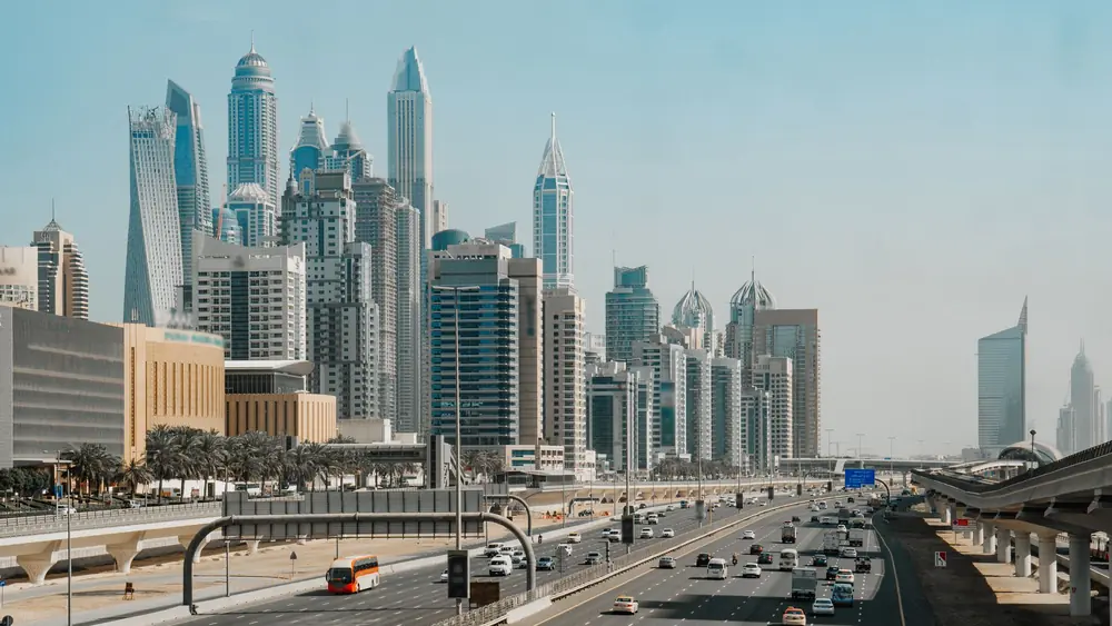 Aerial view of Dubai's skyline with bustling highways showcasing modern architecture.