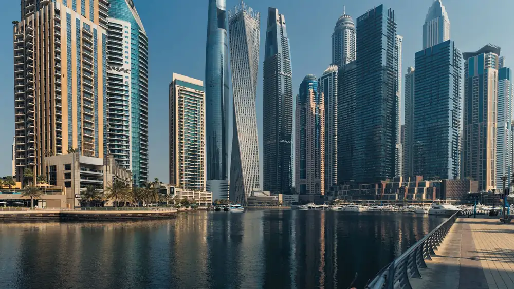 Explore the towering skyscrapers of Dubai Marina reflecting beautifully on the water.