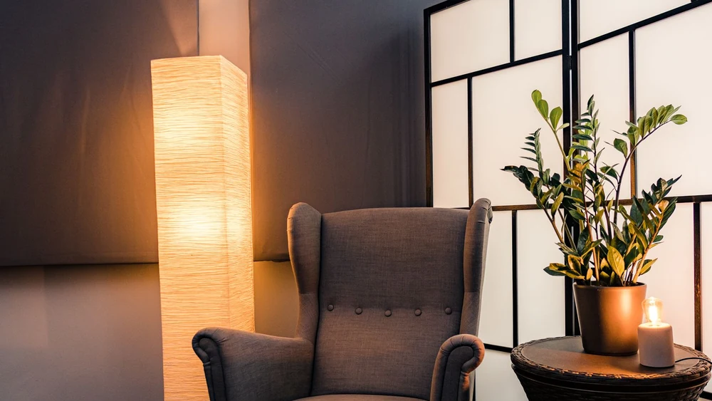 A warm table lamp lighting a room after dark
